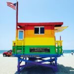 Vibrant rainbow lifeguard tower at Venice Beach, symbolizing LGBTQ+ pride and diversity.