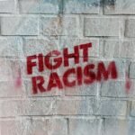 rowemingaround.com Anti-racism graffiti on a wall in Hamburg, promoting social change.
