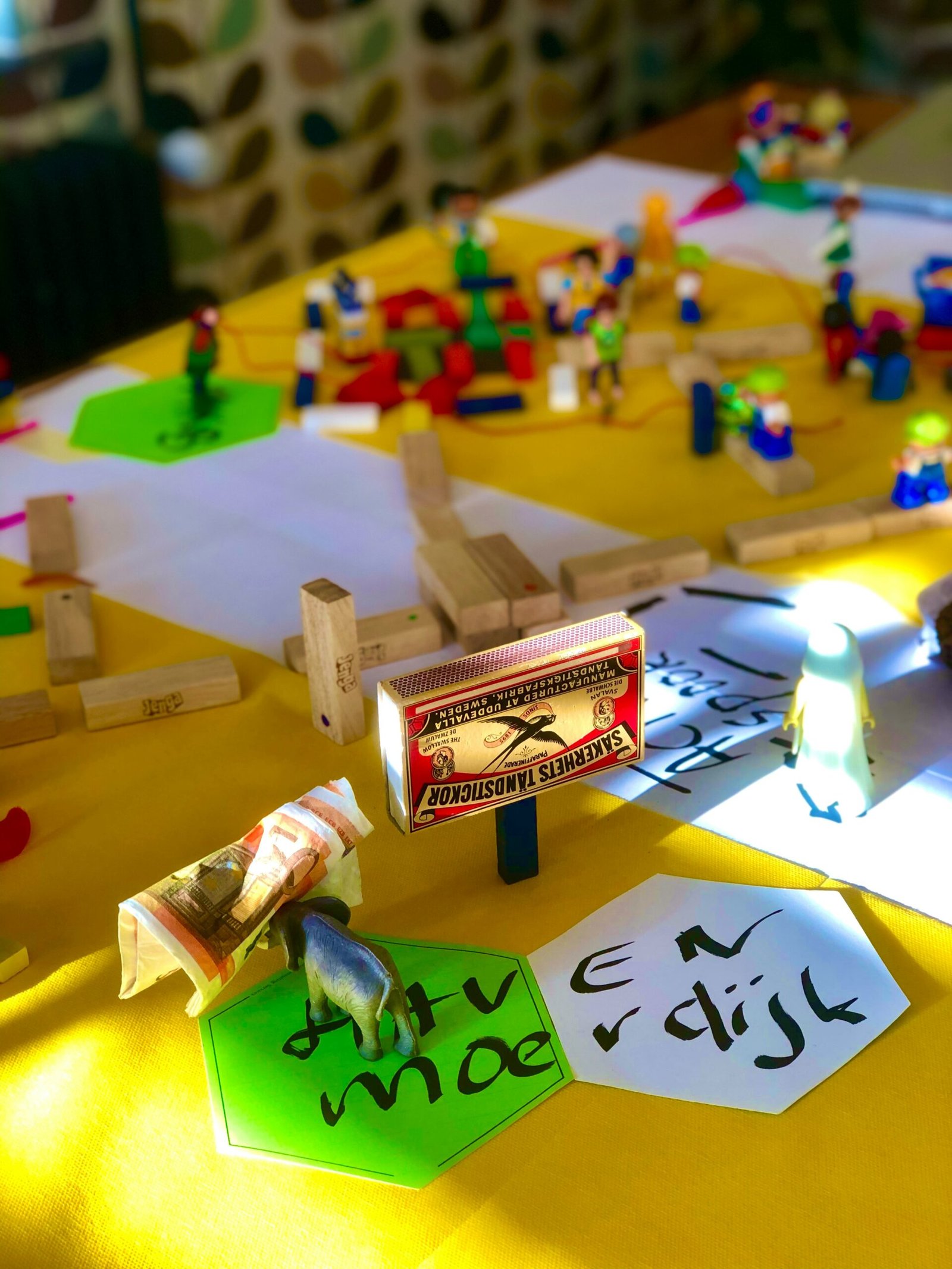 a yellow table topped with legos and a yellow table cloth