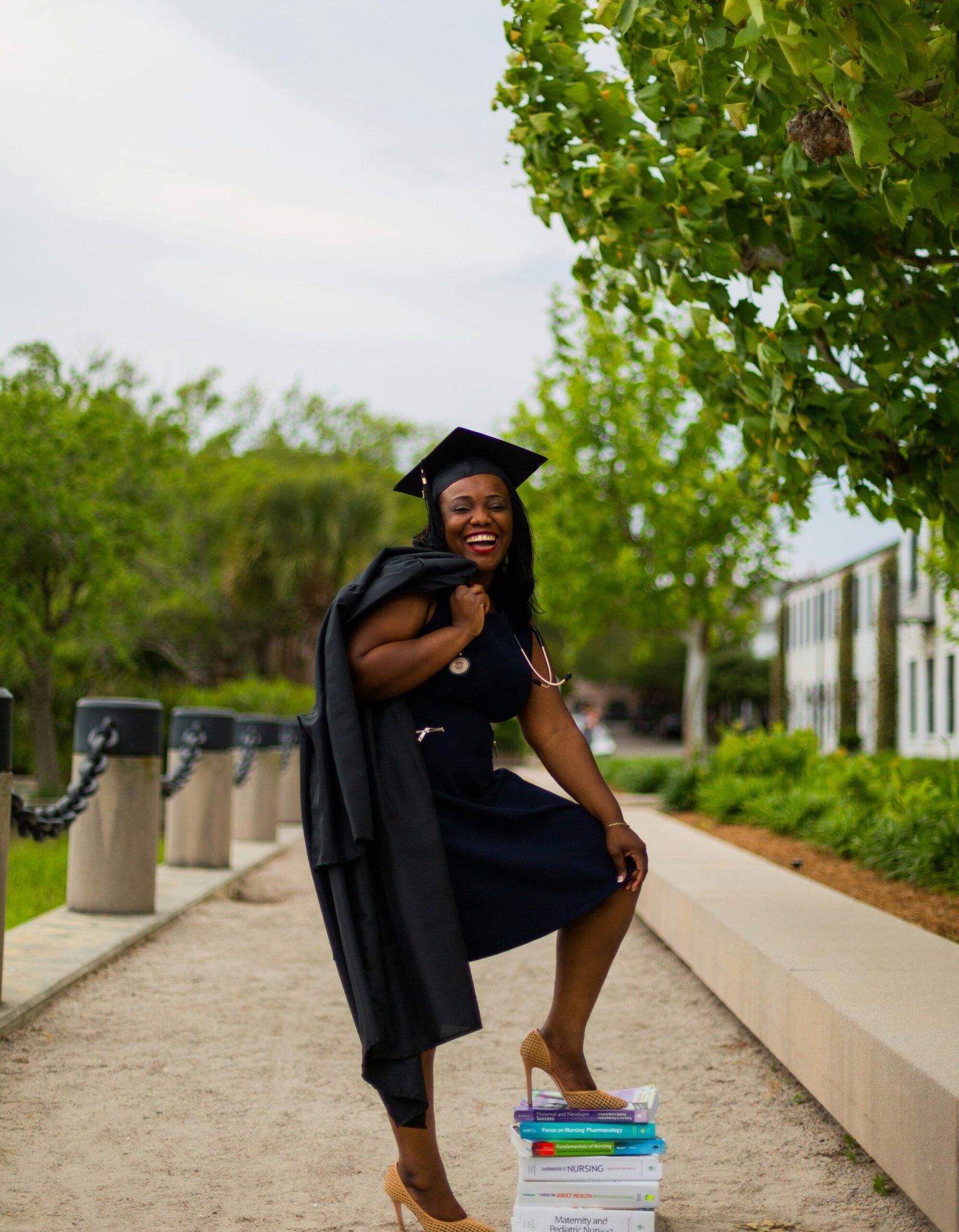 a woman in a graduation gown posing for a picture